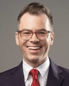 Smiling man in suit and red tie