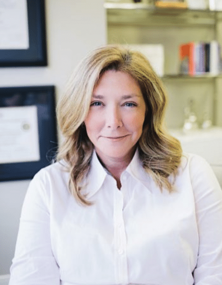 Professional woman in white blouse, office background