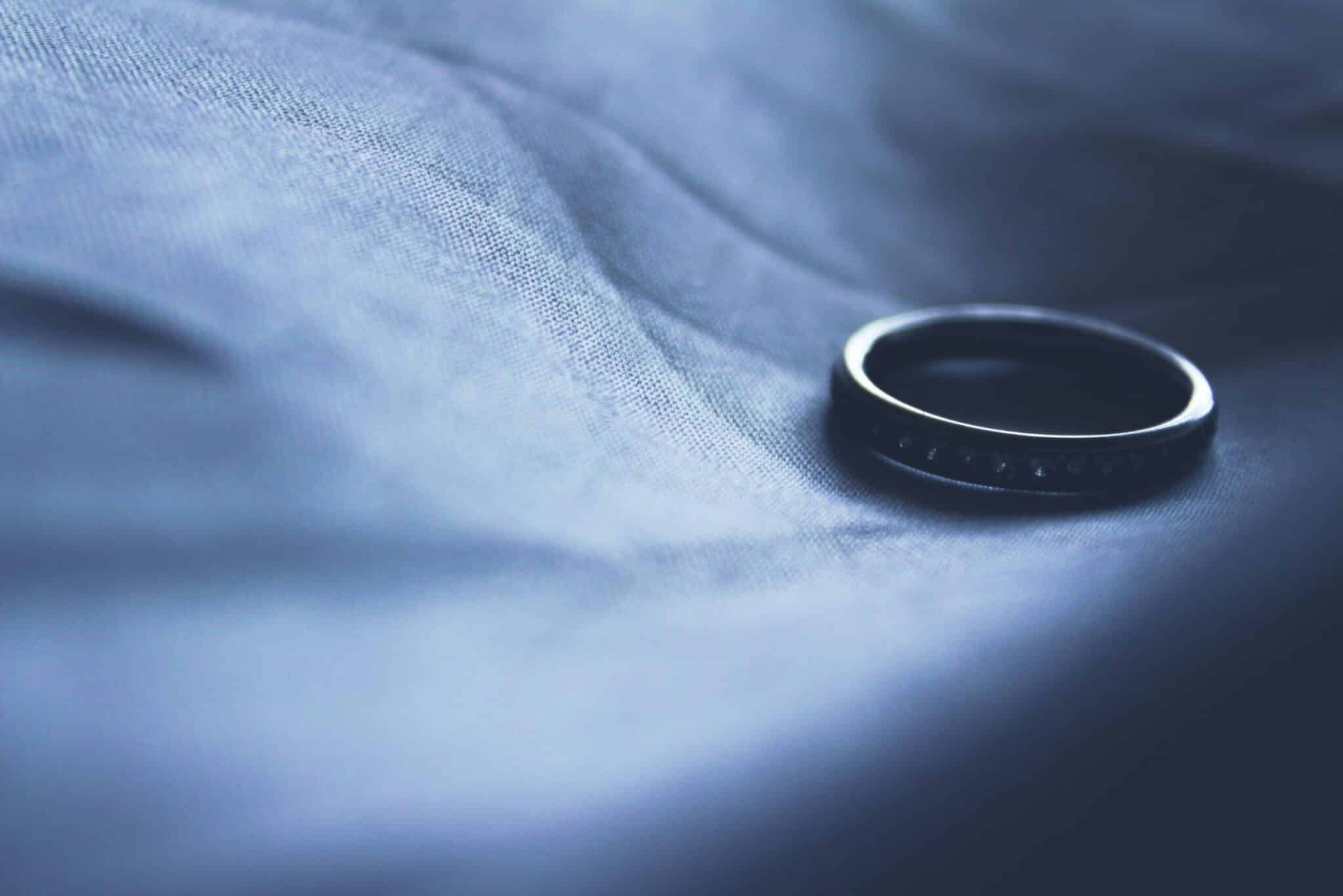 Black ring on soft blue fabric