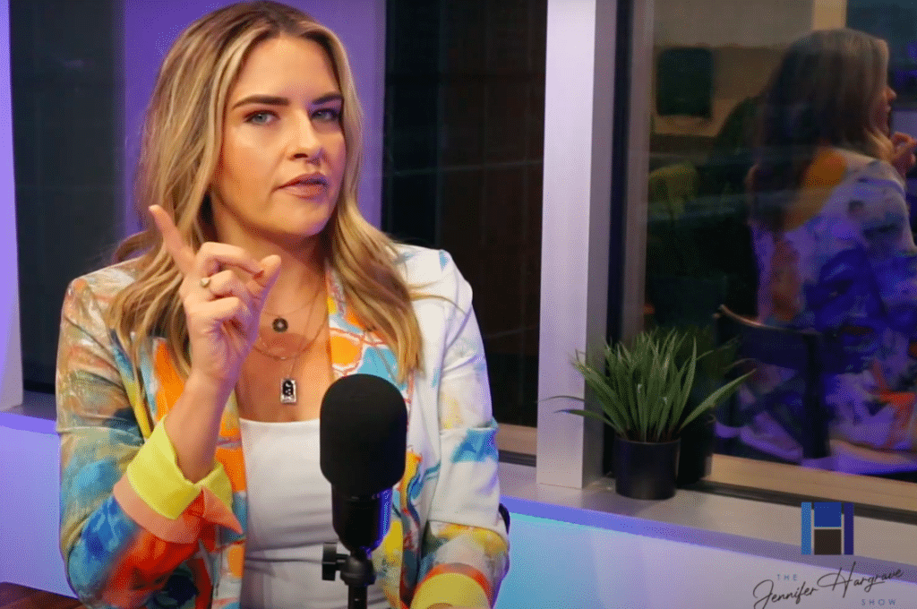 Woman speaking into microphone in colorful studio