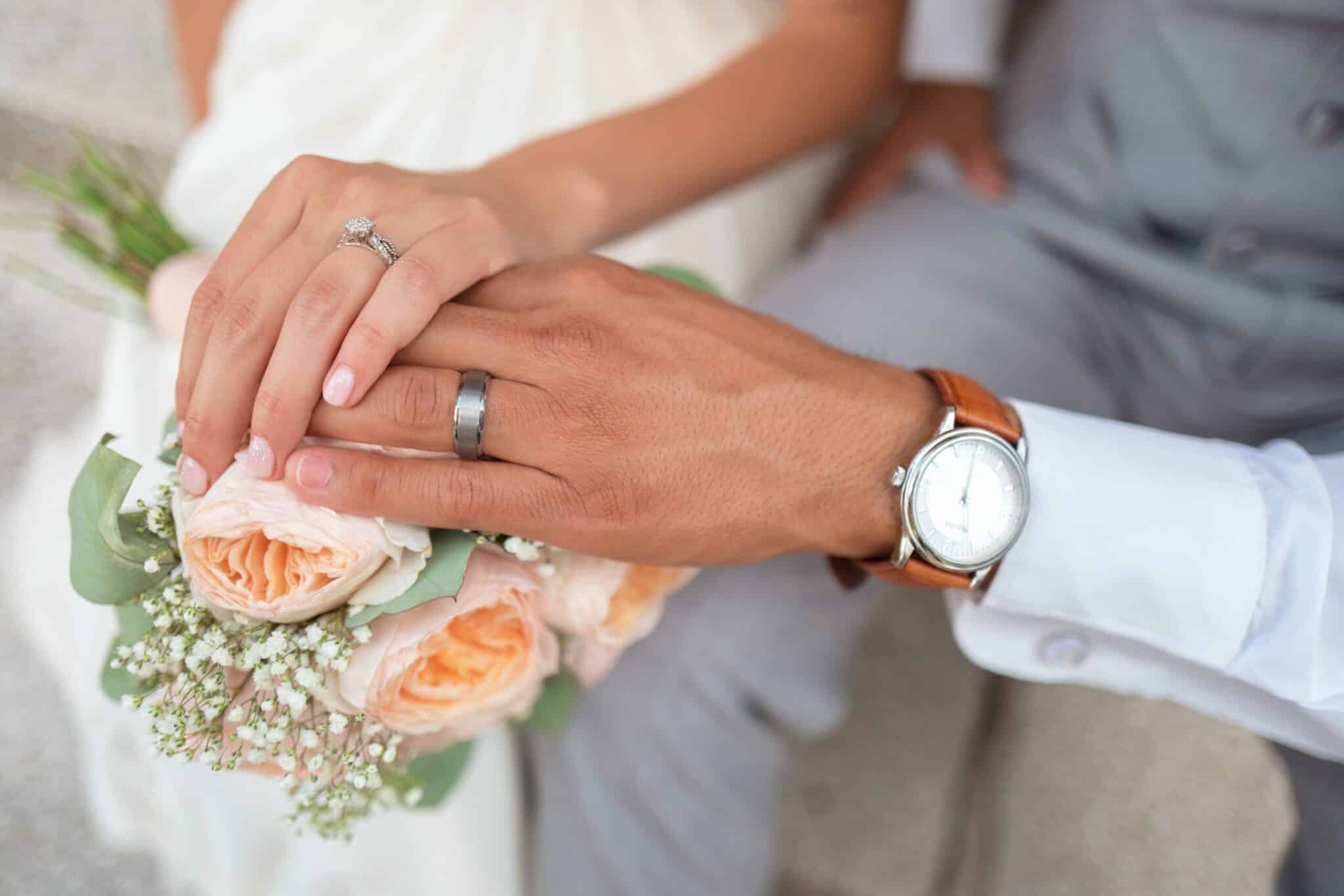 Bride and groom hands with wedding rings