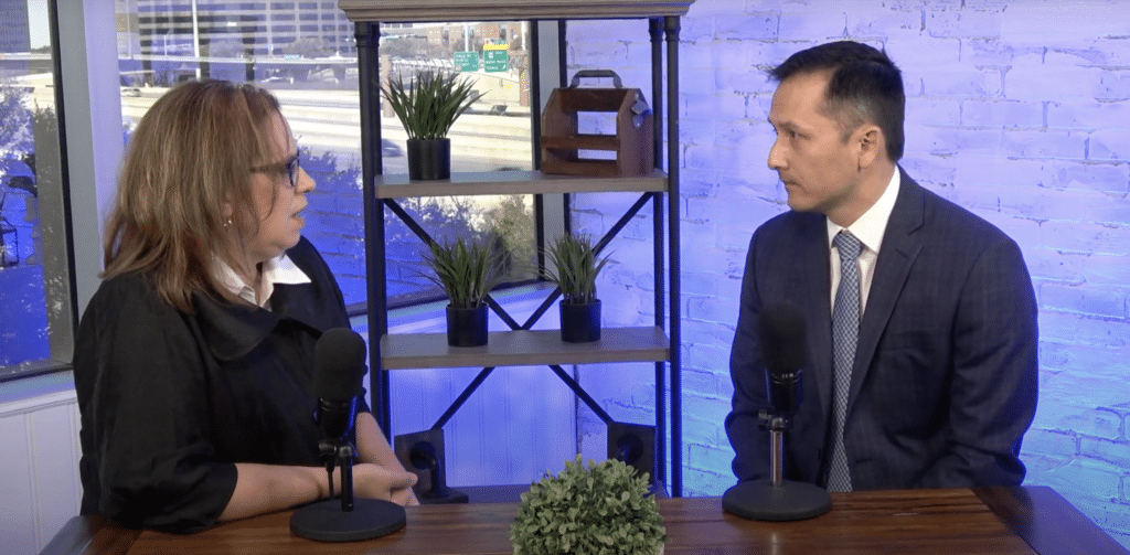 Two professionals speaking during a studio interview