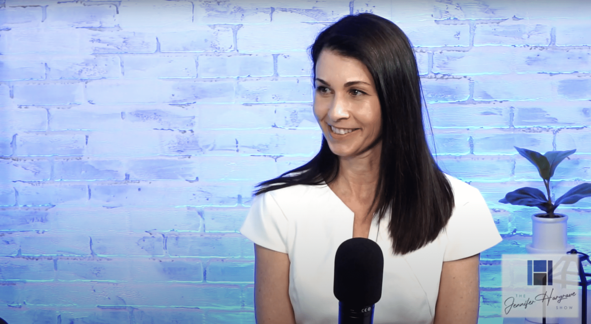 Woman speaking into microphone in studio setting