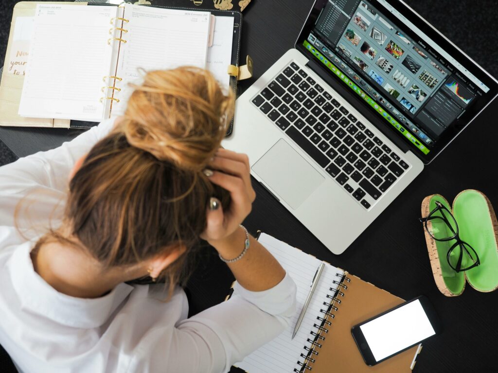 Woman working at desk with laptop and planner