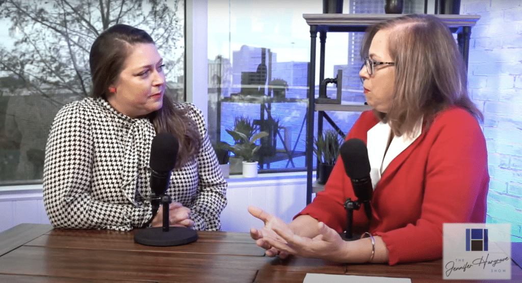 Two women recording a podcast at a table