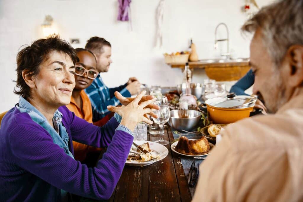 Friends enjoying a meal together at dining table