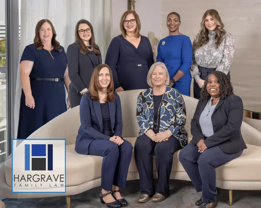 Eight women attorneys posing in office lobby