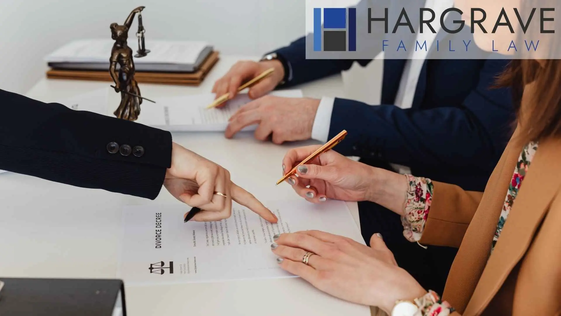 Lawyers review divorce decree with client at desk, hargrave, dallas