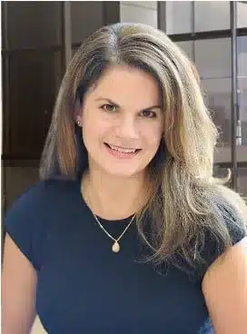 Smiling woman with long brown hair indoors