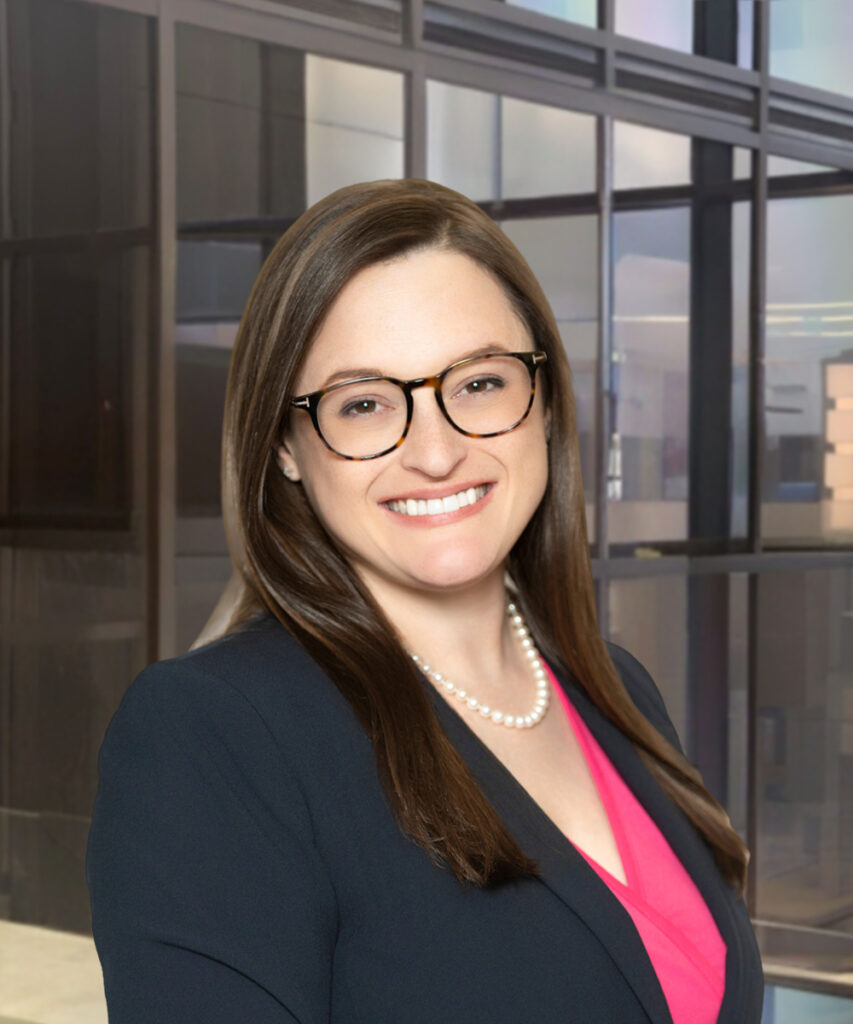 Smiling businesswoman in glasses wearing a navy blazer