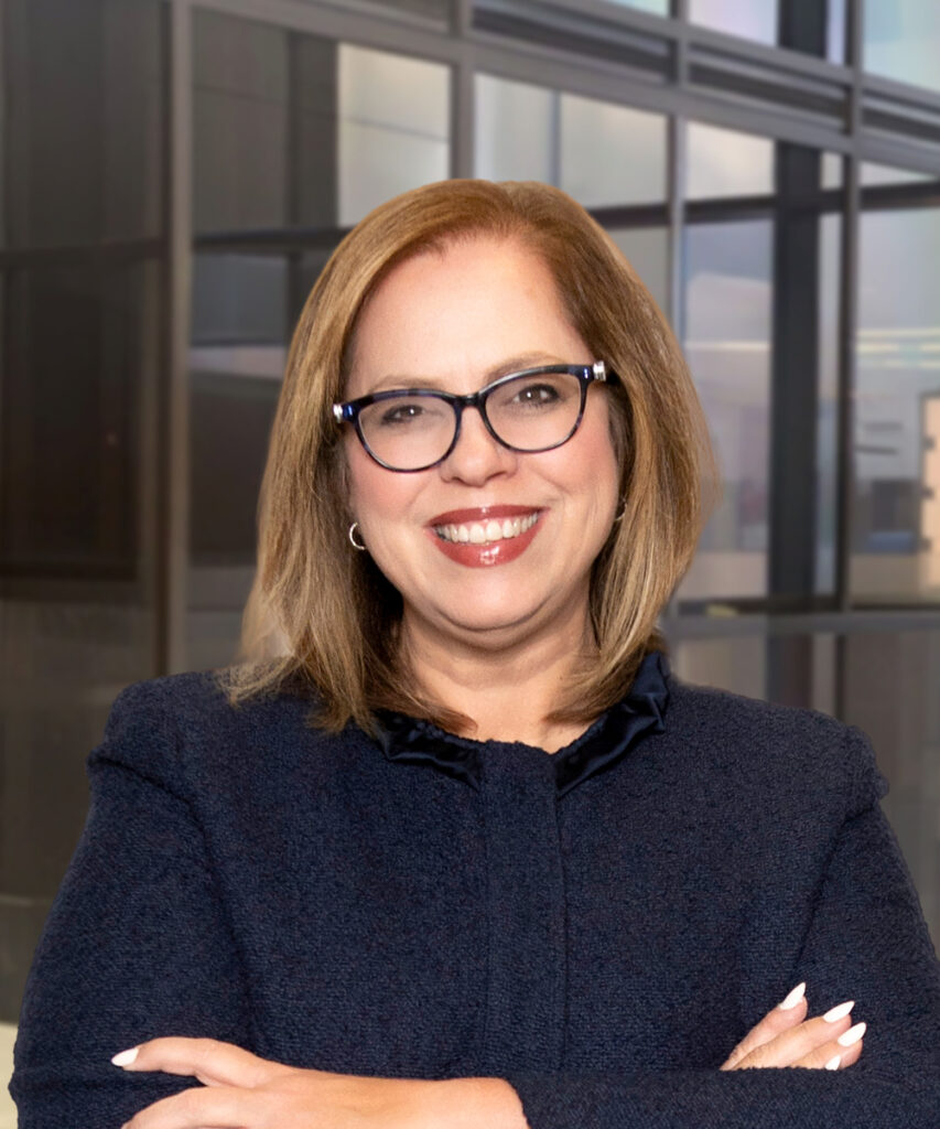 Smiling professional woman with glasses in a modern office