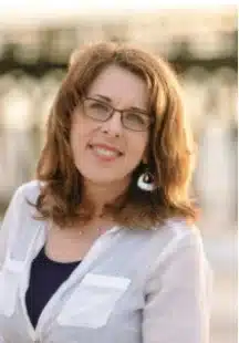 Smiling woman with glasses outdoors