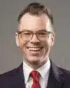Smiling man in glasses and red tie