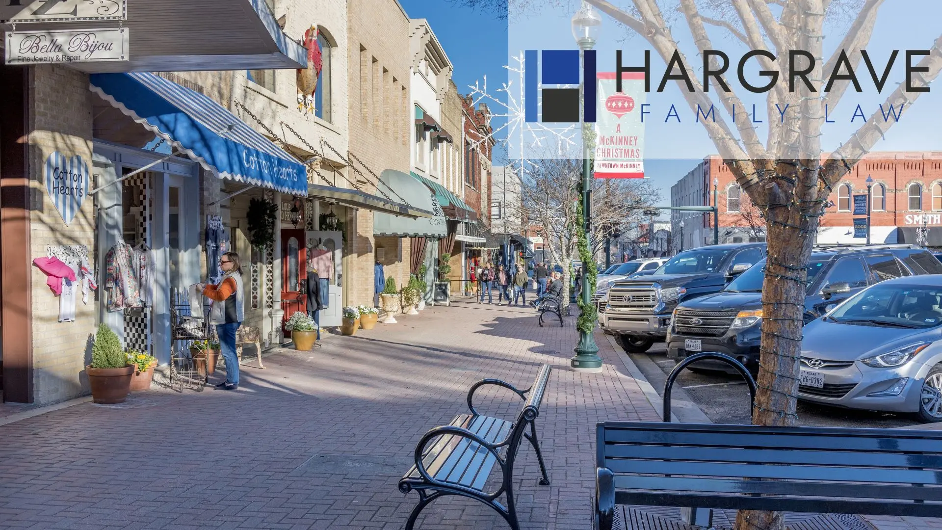Sunny small-town downtown street with shops and parked cars