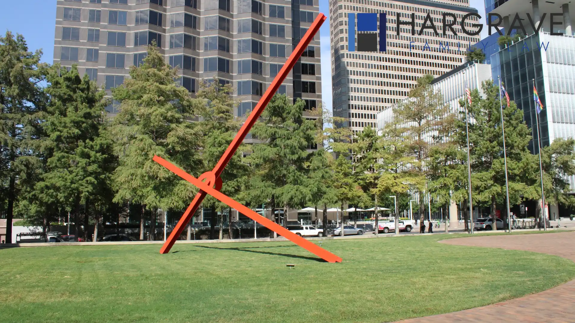 A red steel sculpture on a downtown Dallas lawn, near the offices where engaged couples sign prenuptial agreements.