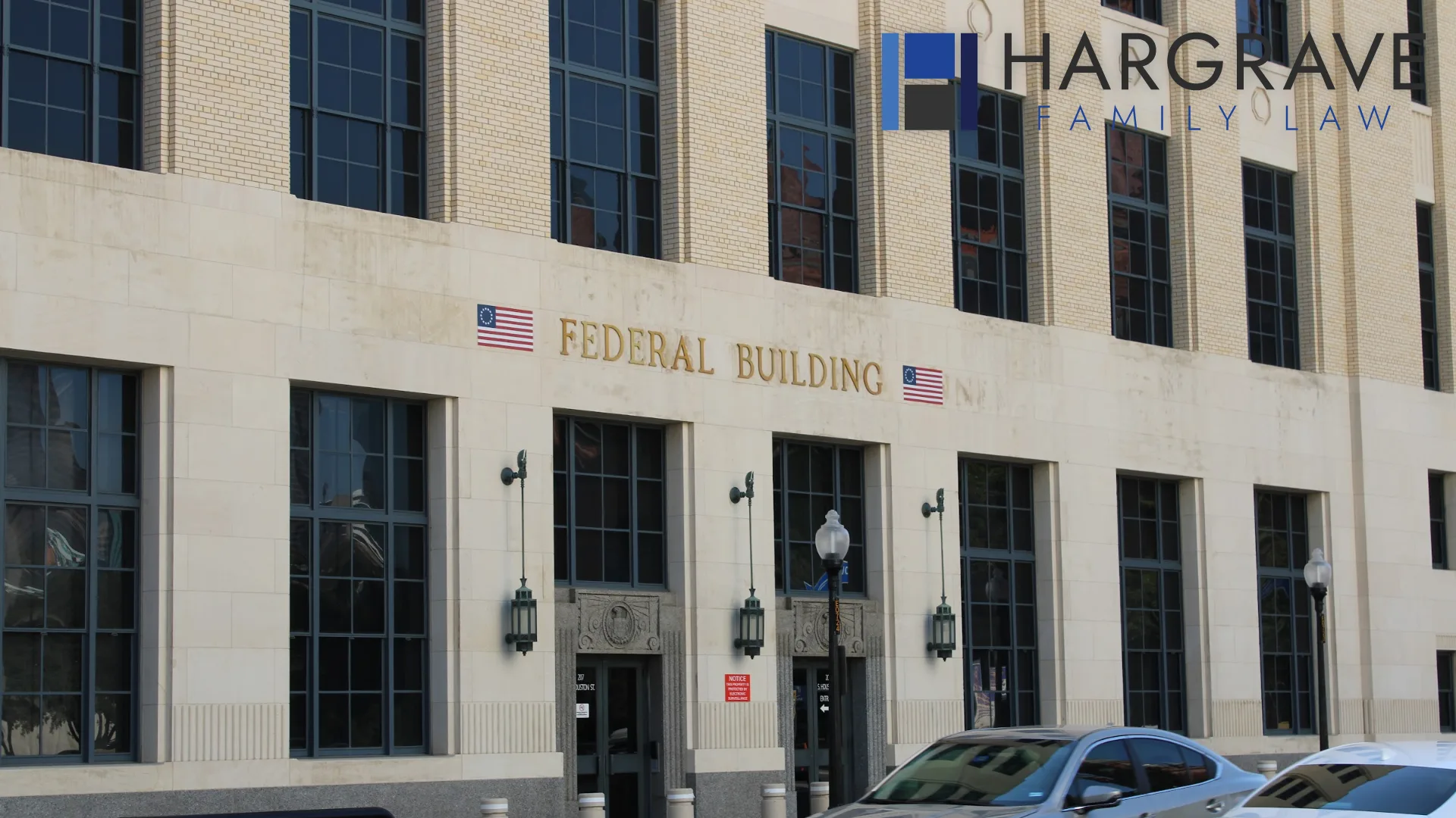 The United States flag flying outside the federal building in downtown Dallas, Texas, where child support orders are established and enforced.